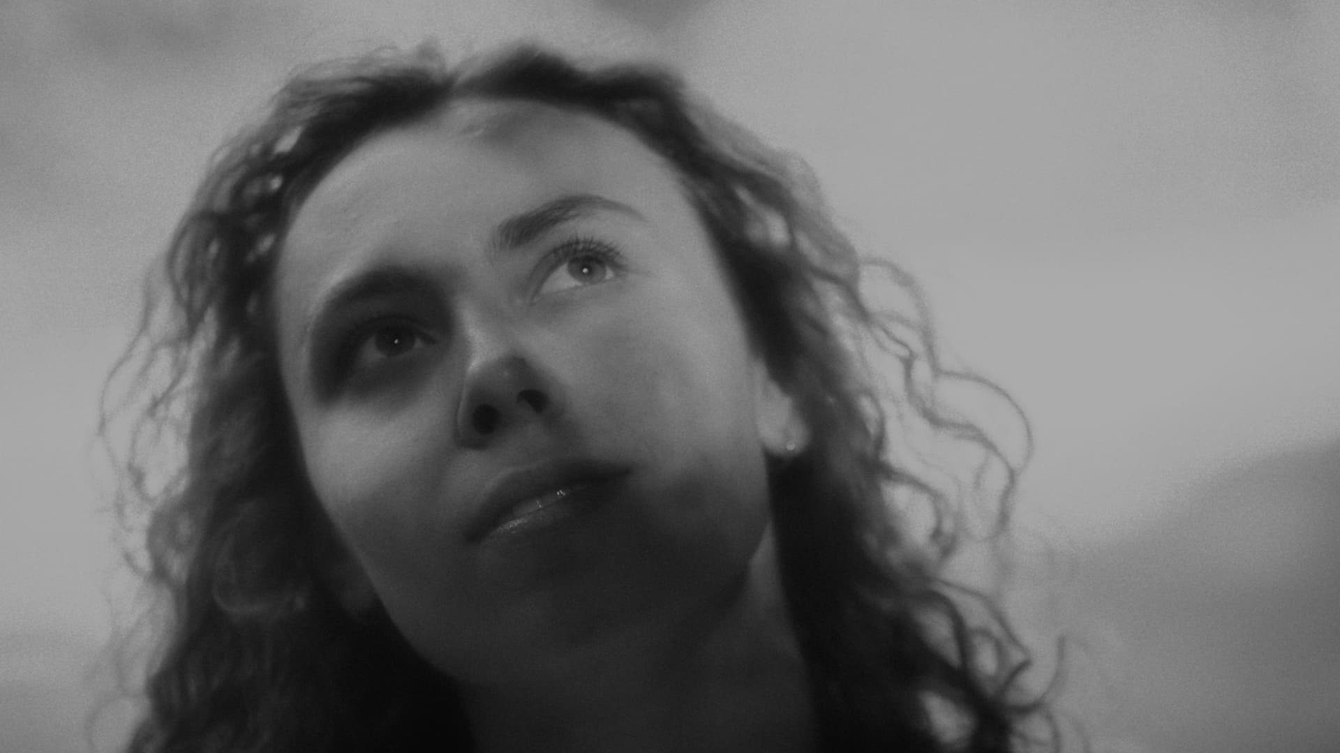 Woman looking up at the sky, black and white